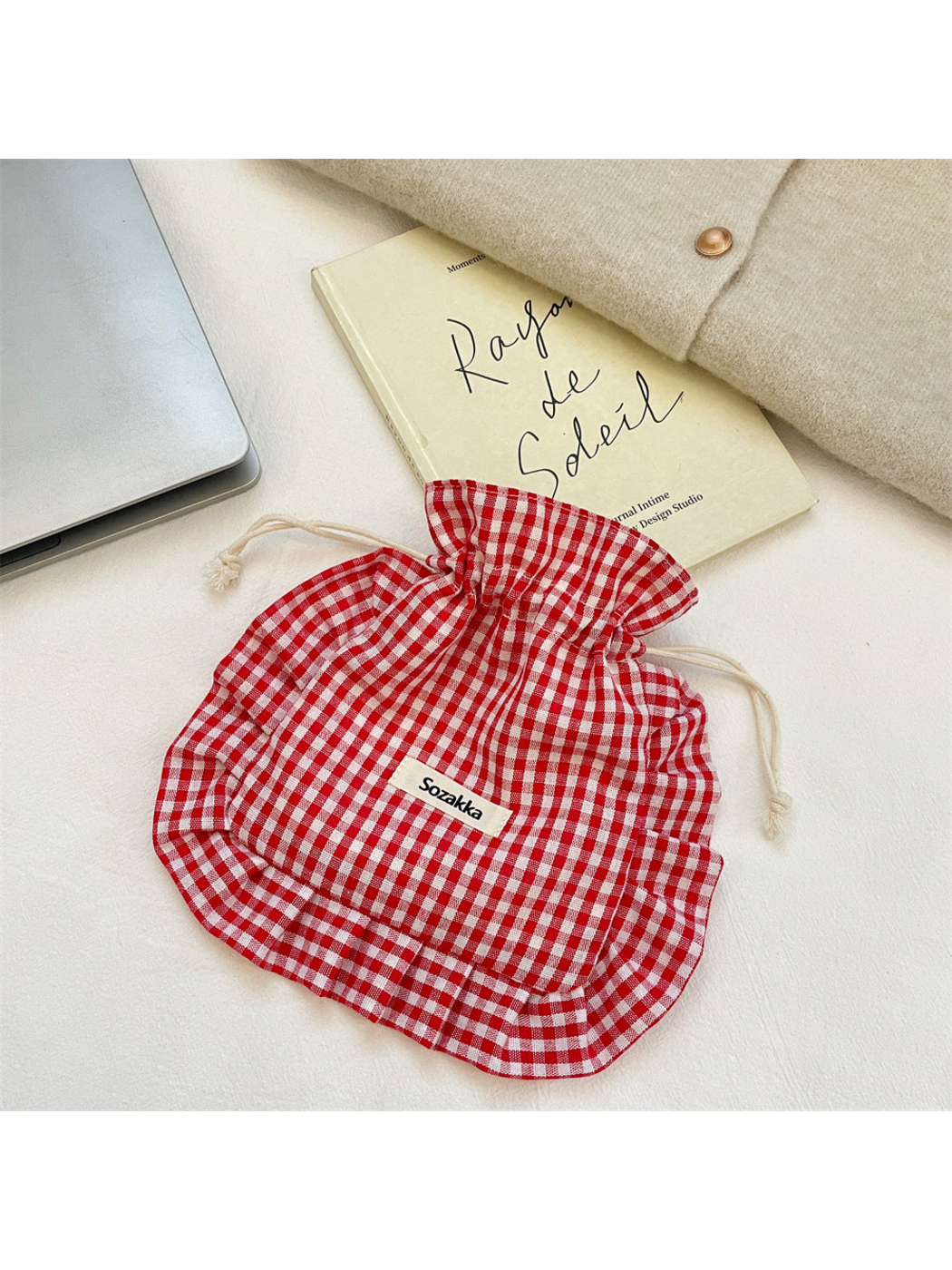 Red gingham drawstring pouch with cream cords and ruffled border, front view