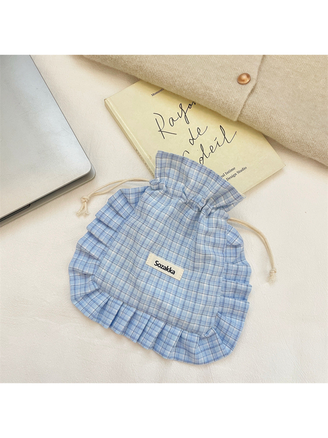 Blue plaid drawstring pouch with cream cords and ruffled trim