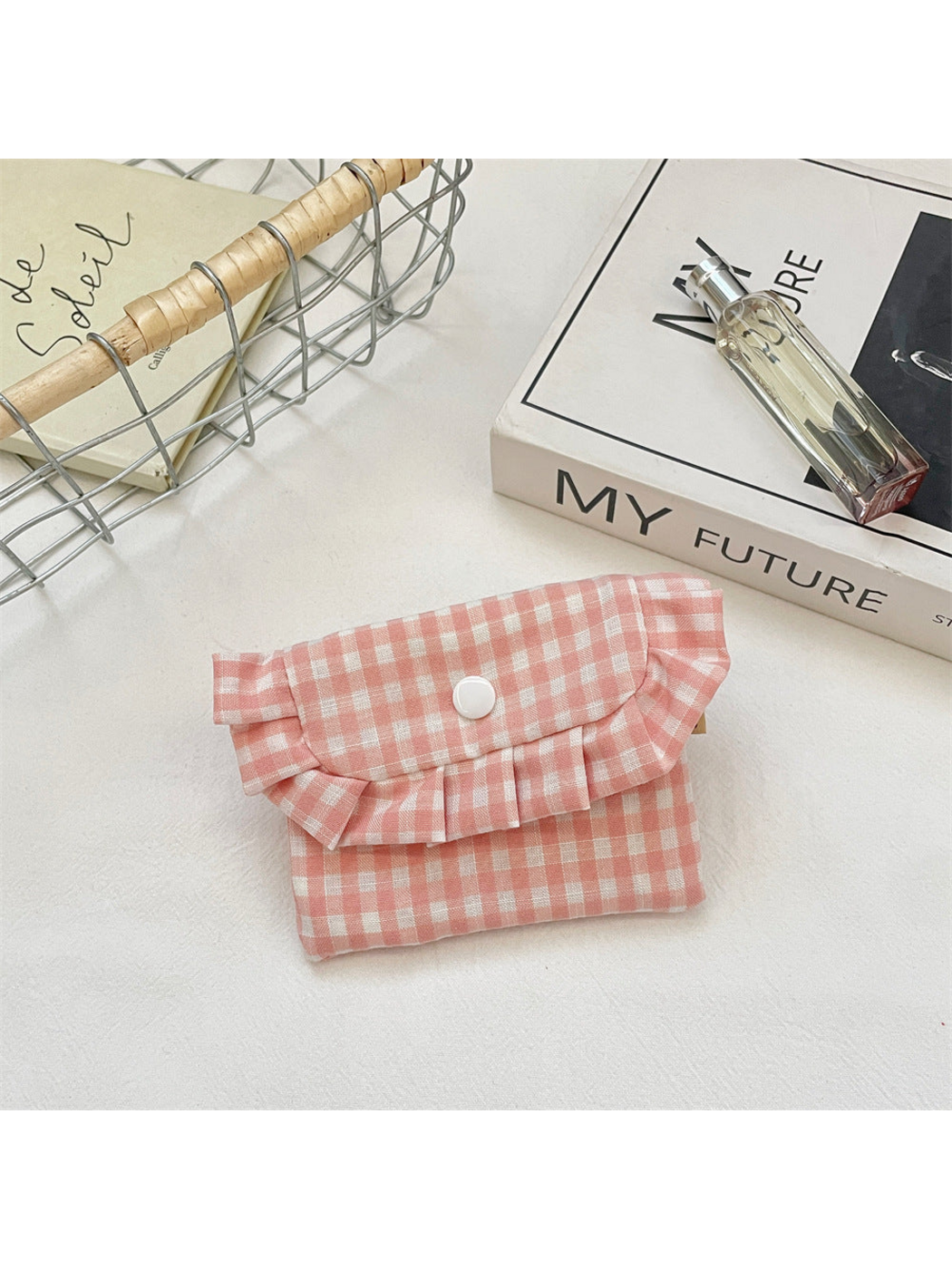 Pink gingham coin purse with a ruffled flap and white snap, front view