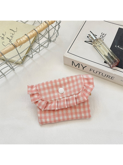 Pink gingham coin purse with a ruffled flap and white snap, front view
