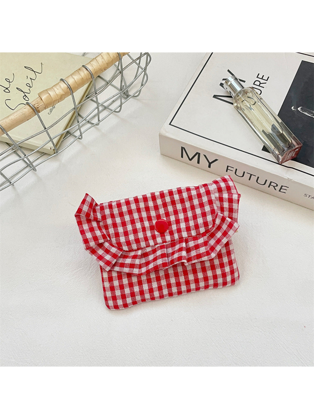 Red gingham coin purse with a ruffled flap and red snap, front view