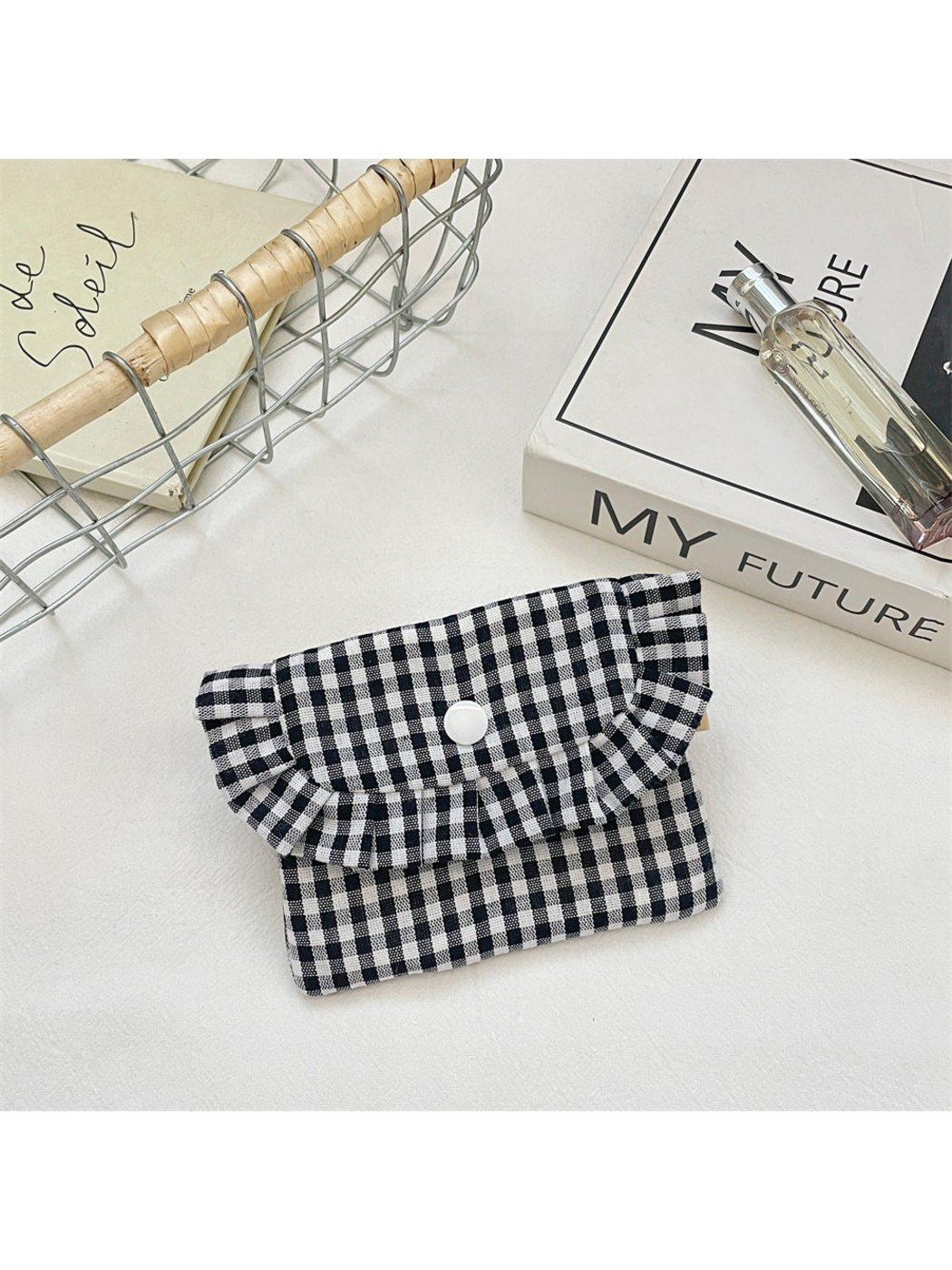 Black gingham coin purse with a ruffled flap and white snap, front view