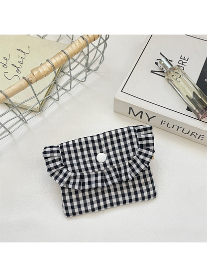 Black gingham coin purse with a ruffled flap and white snap, front view