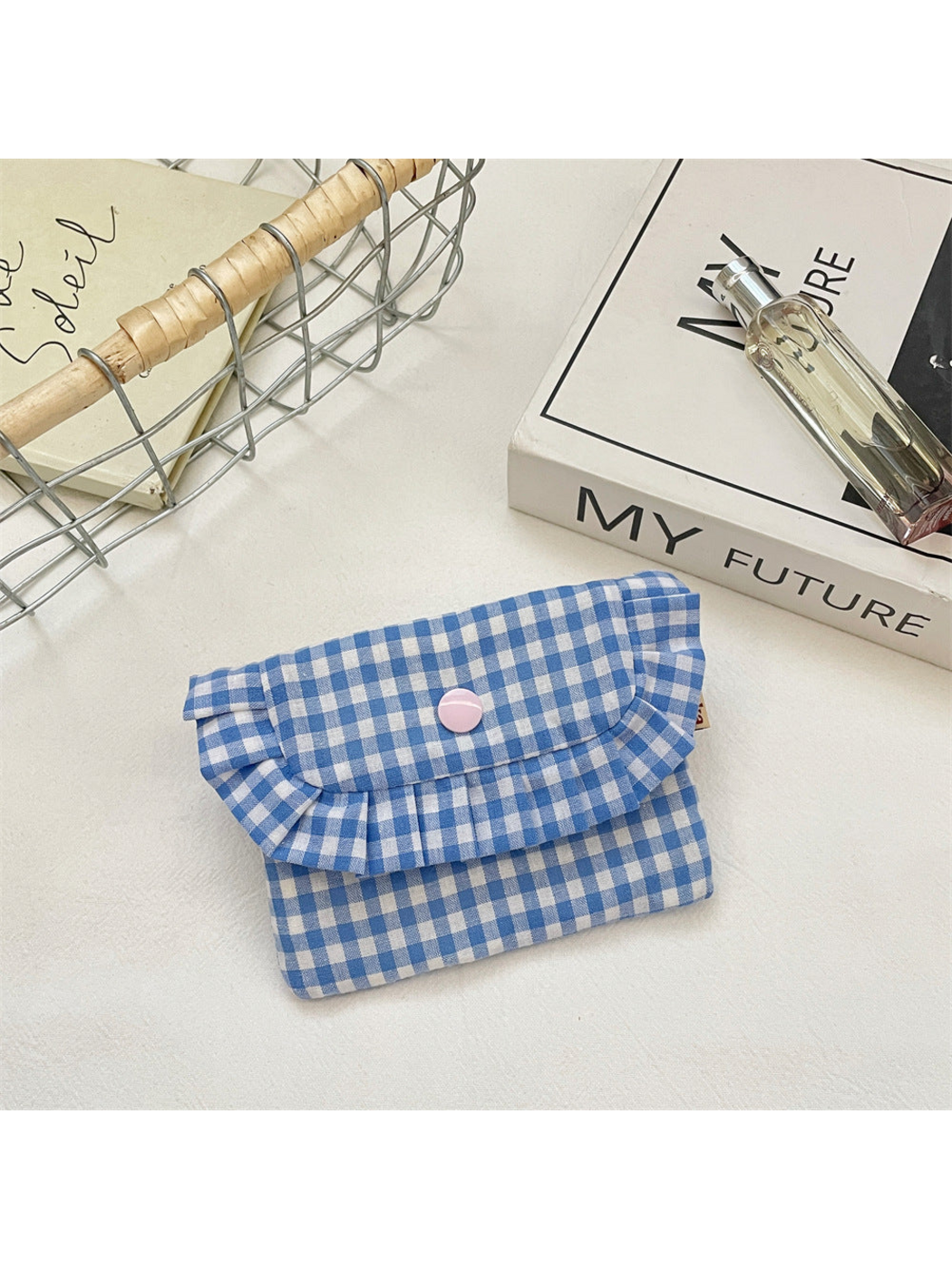 Blue gingham coin purse with a ruffled flap and pink snap, front view