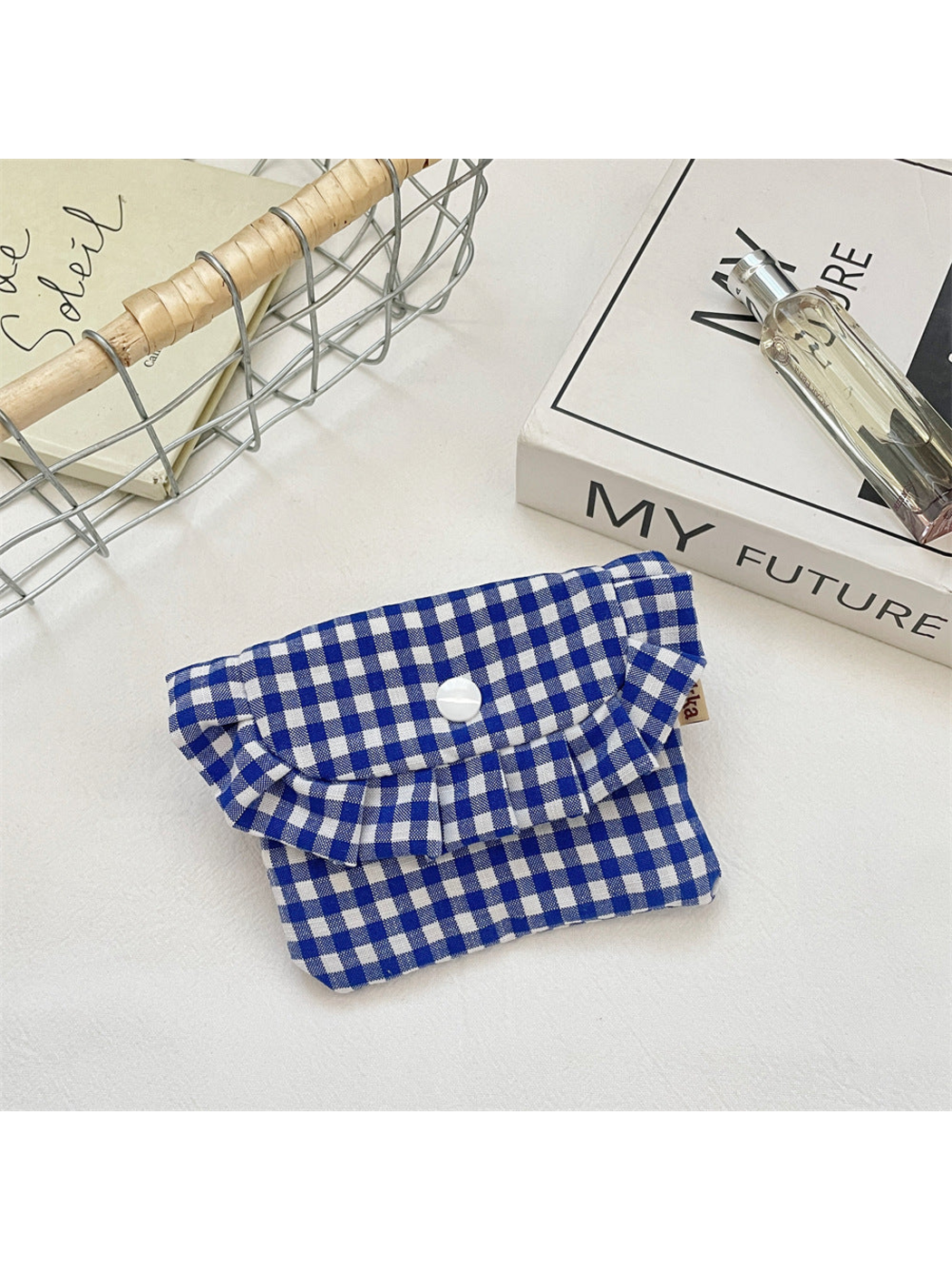 Blue gingham coin purse with a ruffled flap and centered white snap