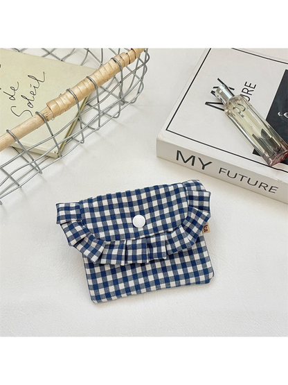 Navy gingham coin purse with a ruffled flap, white snap and tan side tab