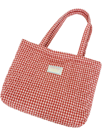 Red and white gingham quilted tote bag with matching handles and an attached front label