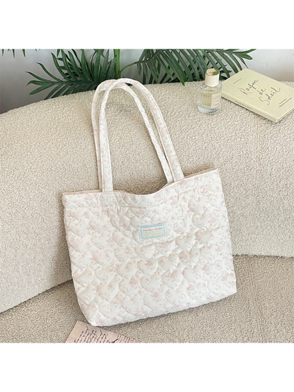 Pink floral quilted tote bag with long handles, front view