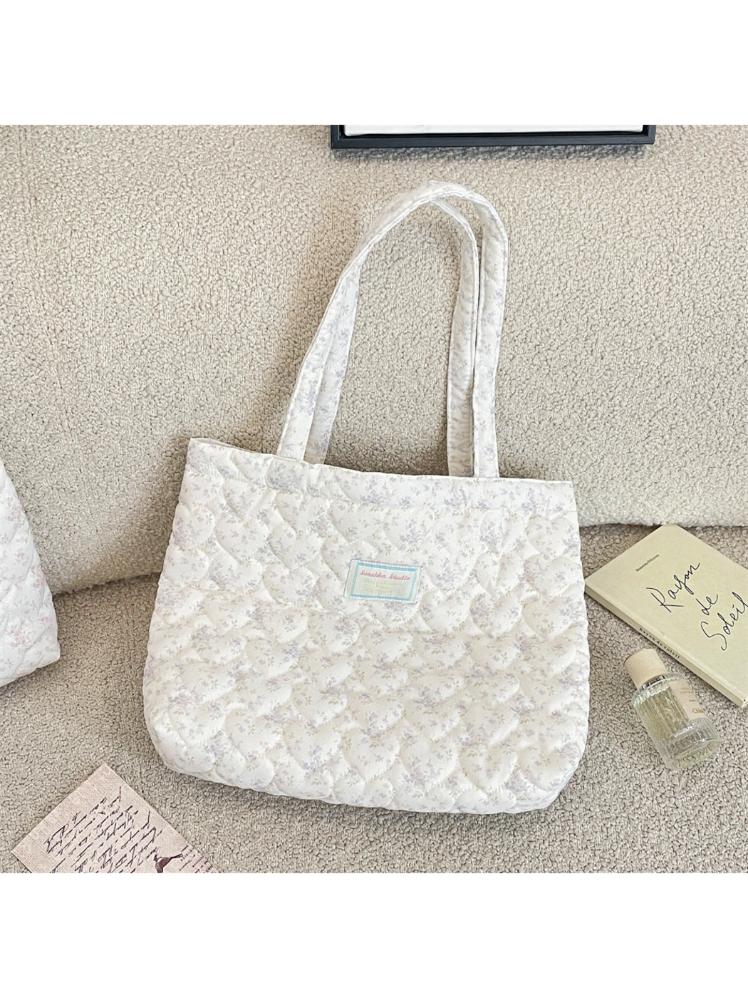 Gray floral quilted tote bag with long handles, front view