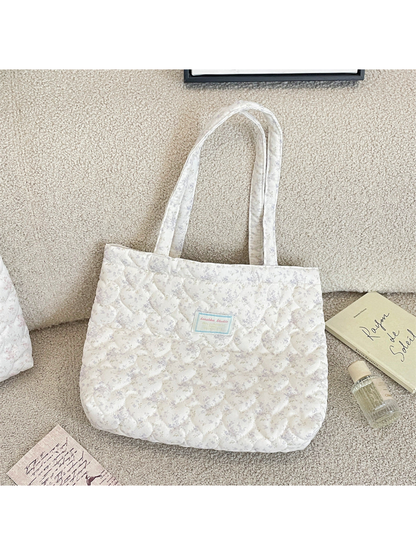 Gray floral quilted tote bag with long handles, front view