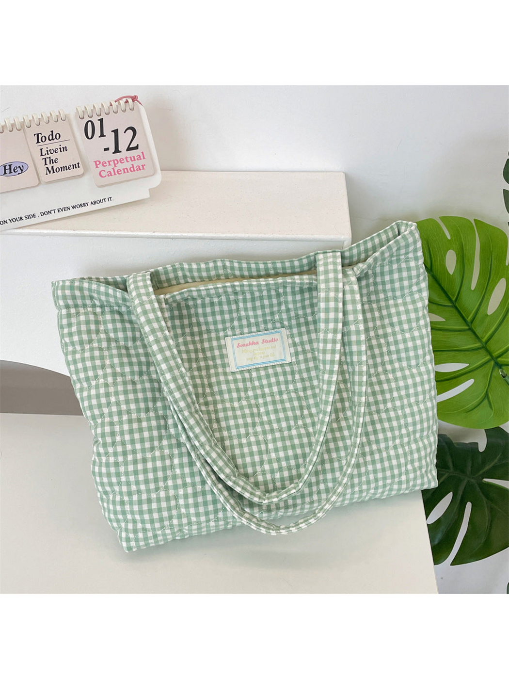 Green gingham tote with heart-shaped quilting and two long handles
