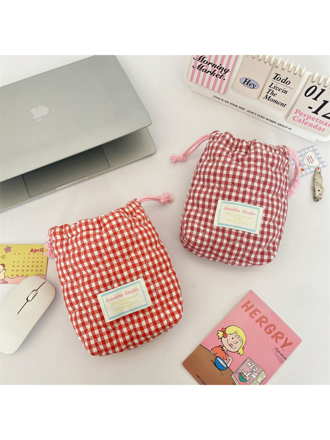 Red and Pink gingham drawstring pouches displayed together, showing heart-shaped quilting and front labels