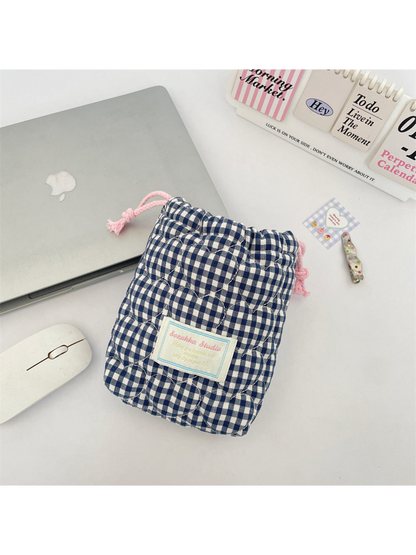 Navy gingham drawstring pouch with heart-shaped quilting and pink drawstrings, front view