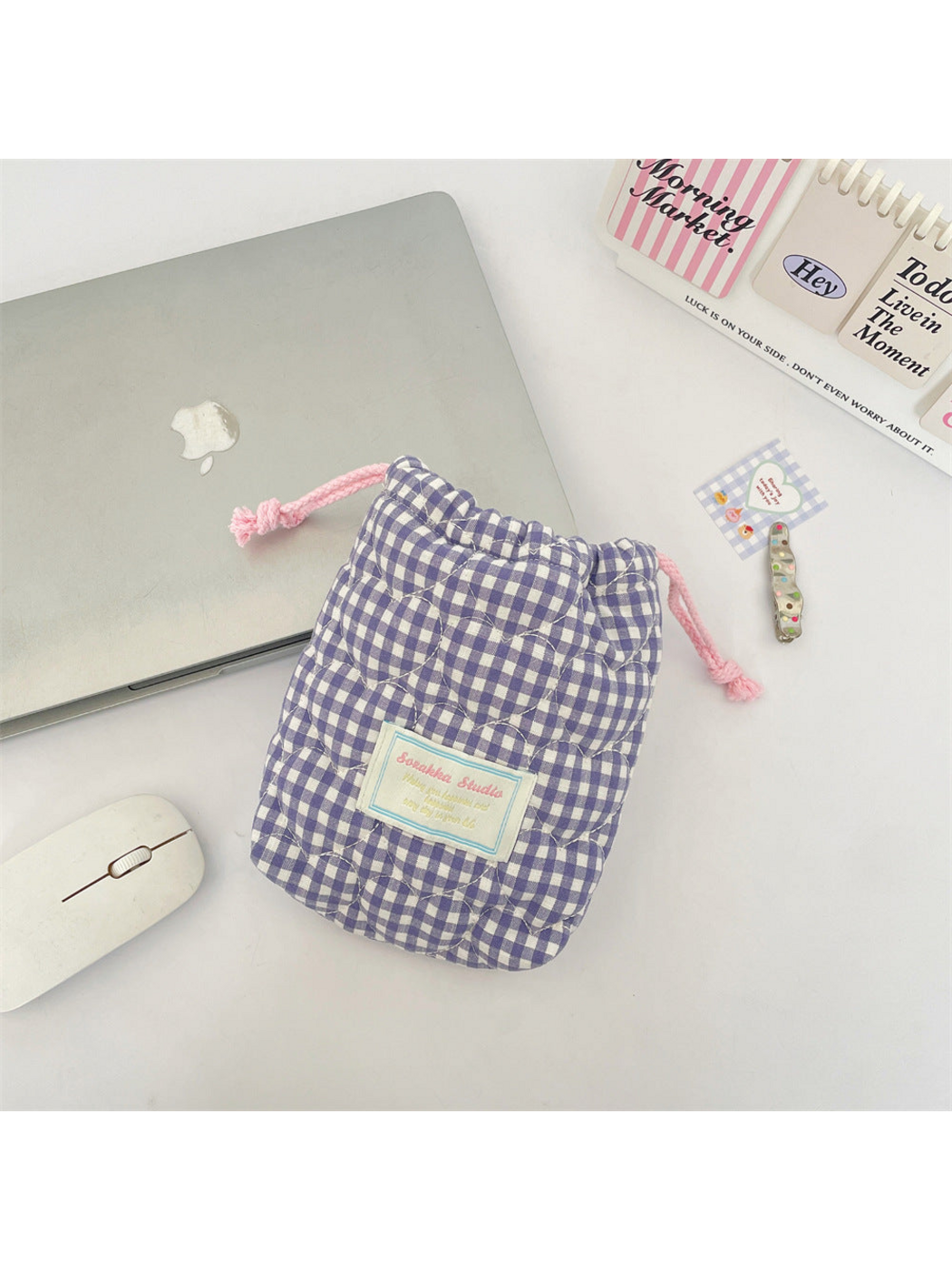 Purple gingham drawstring pouch with pink drawstrings and heart-shaped quilting, front view