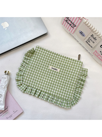 Green gingham makeup pouch with ruffled edging, flat view
