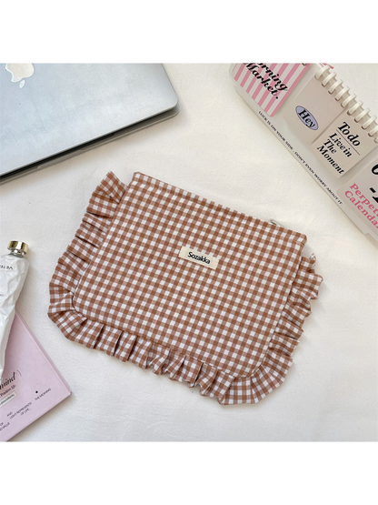 Brown gingham makeup pouch with ruffled edging, flat view