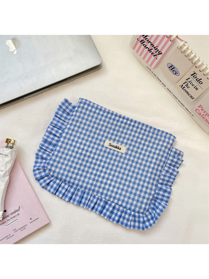 Blue gingham makeup pouch with ruffled edging, flat view