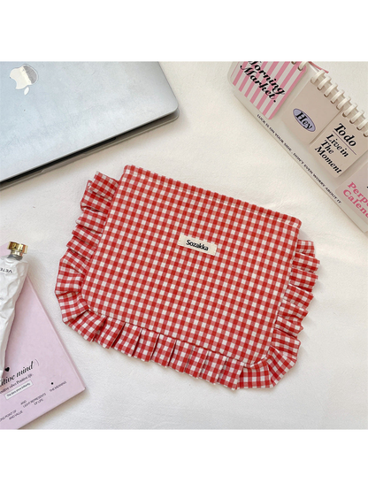 Red gingham cosmetic pouch with white checks and ruffled trim, flat front view