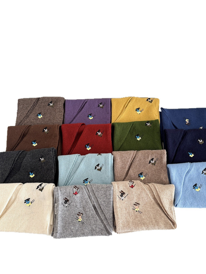 Folded knit scarves displaying embroidered winter-sport figures