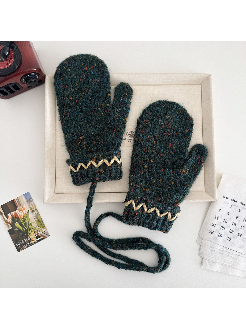 Deep Teal flecked mittens with cream zigzag cuffs and a connecting cord