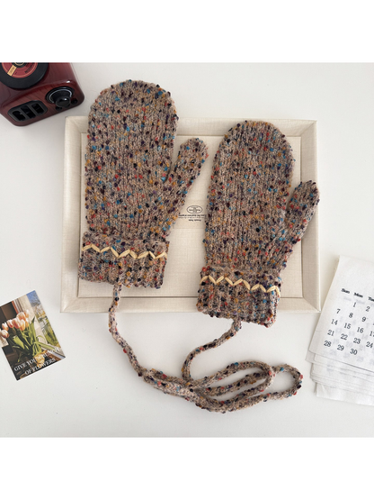 Brown flecked mittens with cream zigzag cuffs and a connecting cord
