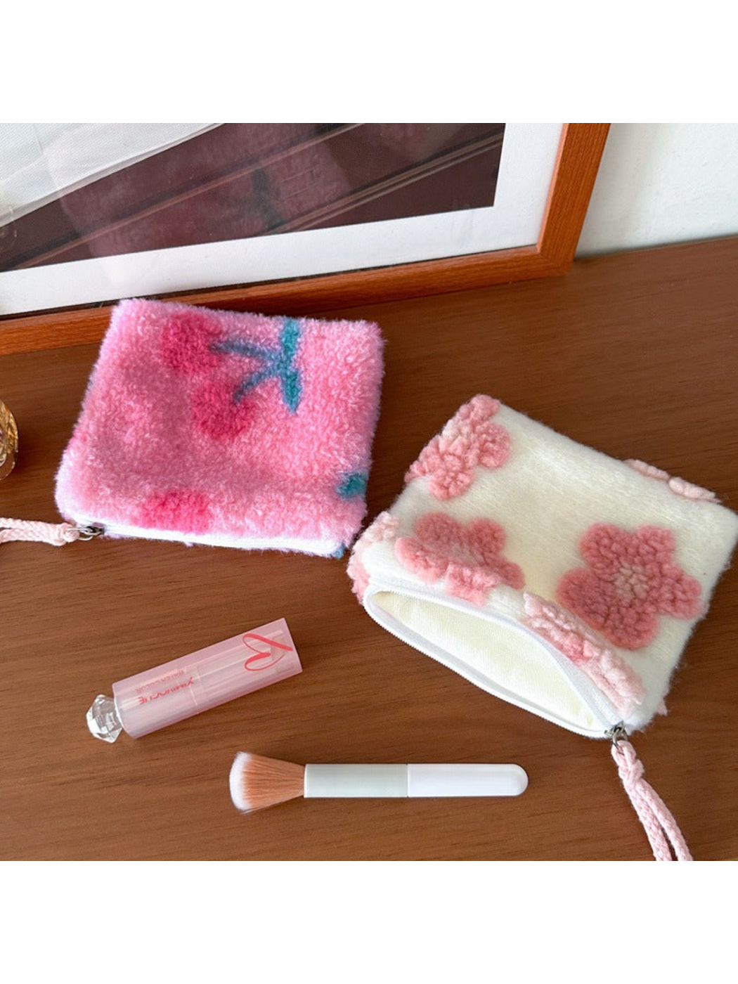 Cherries and Flowers makeup bags, with the Flowers bag open to show its cream-colored lining