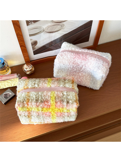 Yellow and Blush makeup bags with looped surface texture on a wooden tabletop