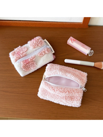 Flowers makeup bag beside an open Stripes makeup bag with pale pink lining