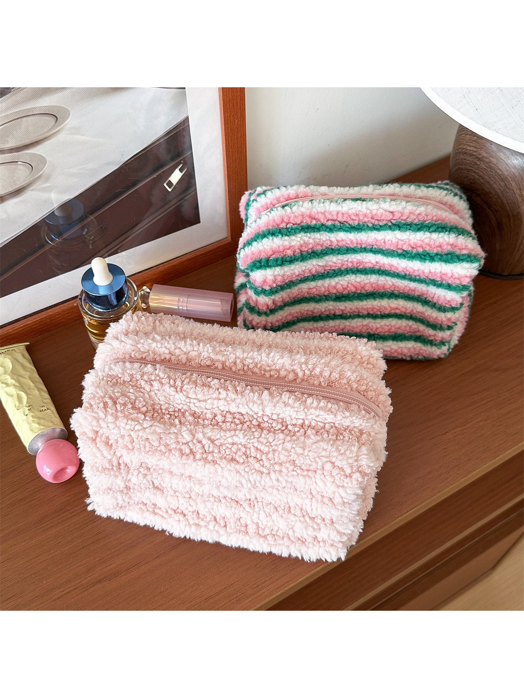 Light Pink and Green cosmetic pouches with textured horizontal bands, viewed from above