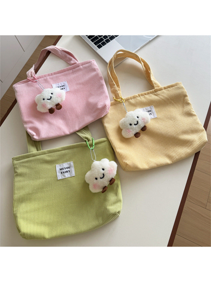 Pink, Yellow and Green ribbed tote bags with smiling cloud charms displayed together