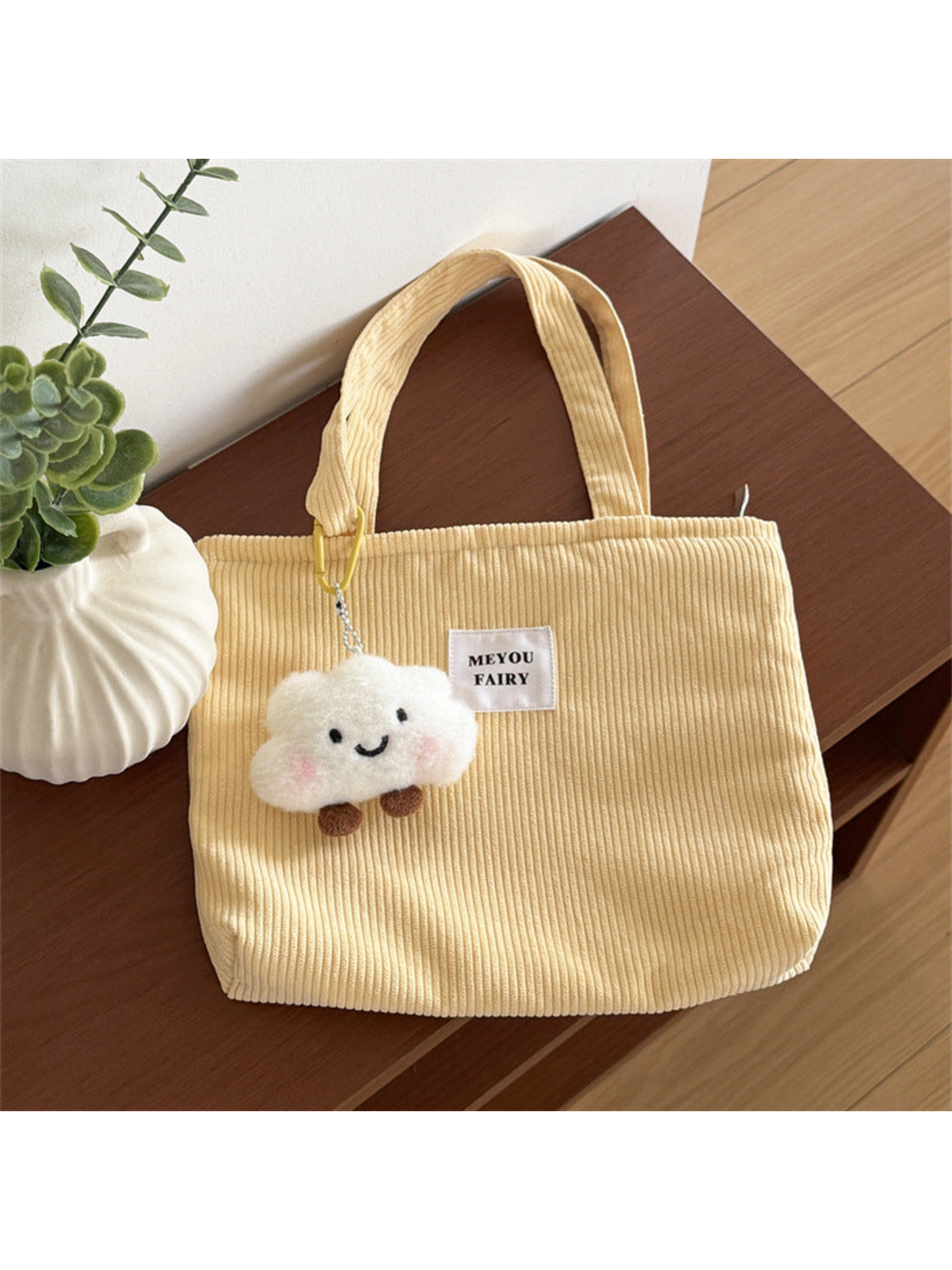 Yellow ribbed tote bag with white front patch and smiling cloud charm