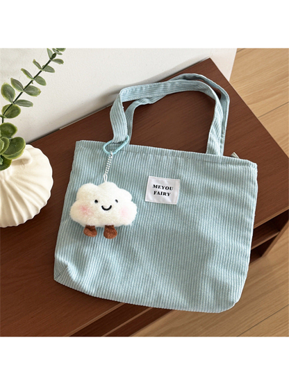 Blue ribbed tote bag with two top handles and smiling cloud charm