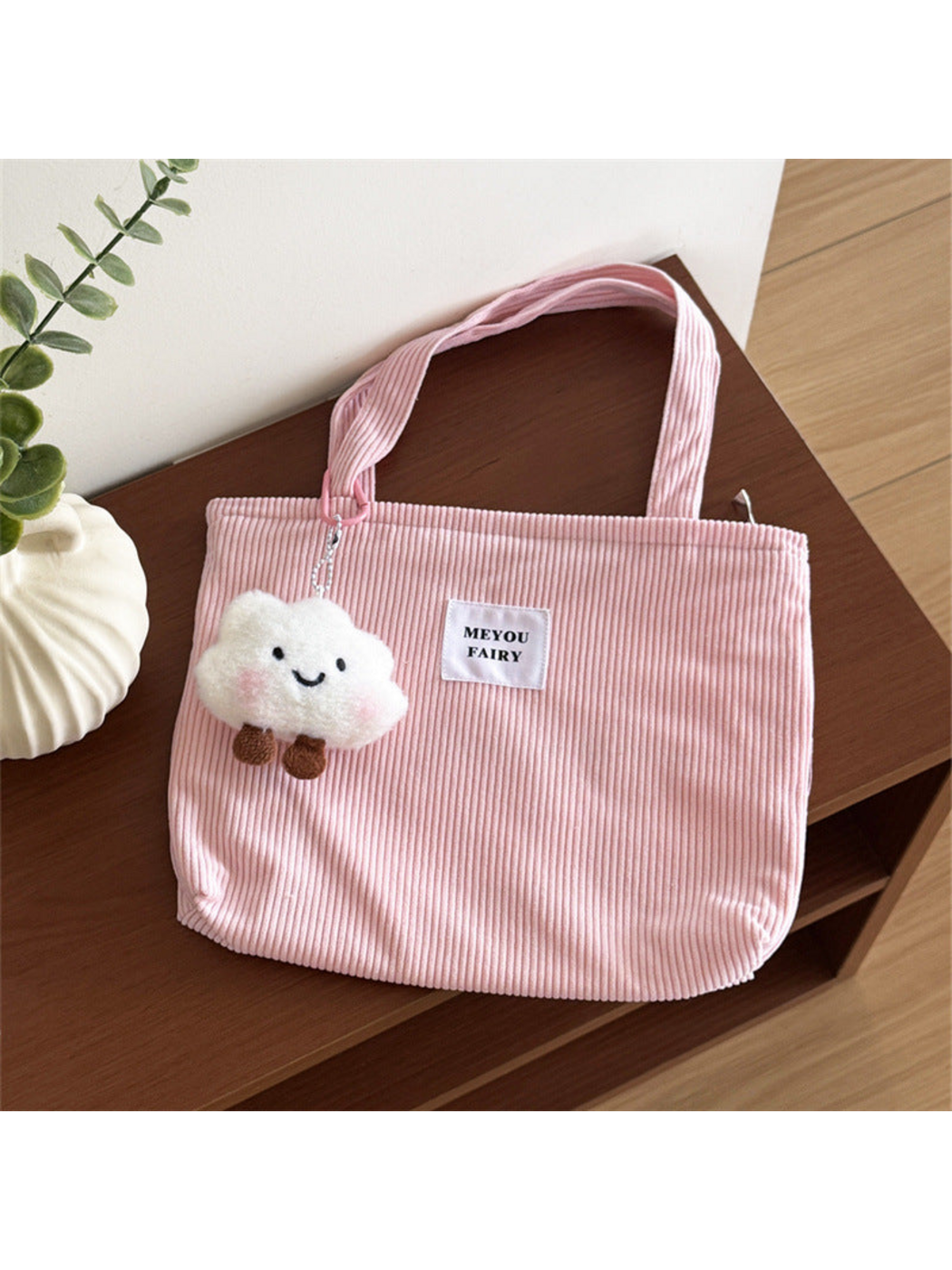 Pink ribbed tote bag with white front patch and smiling cloud charm