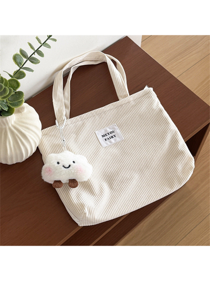 Beige ribbed tote bag with two top handles and smiling cloud charm