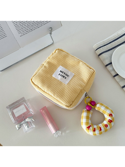 Yellow ribbed makeup bag with yellow checked charm