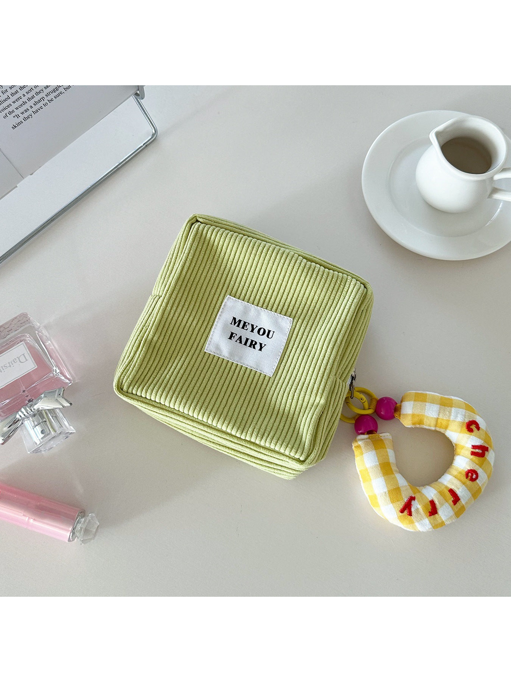 Green ribbed makeup bag with yellow checked charm