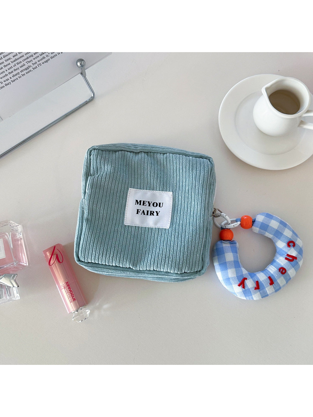 Blue ribbed makeup bag with blue checked charm