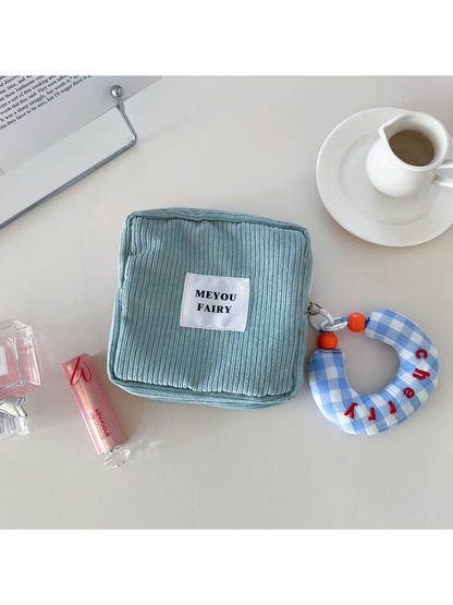 Blue ribbed makeup bag with blue checked charm