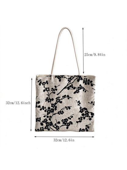 Black flowering-branch tote bag with body and handle-drop measurements