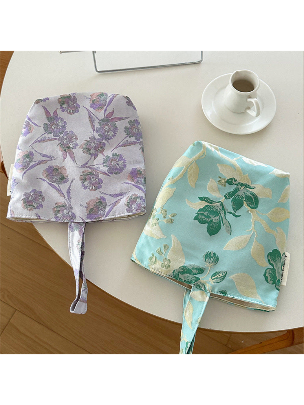 Purple and Turquoise floral bucket bags displayed flat together