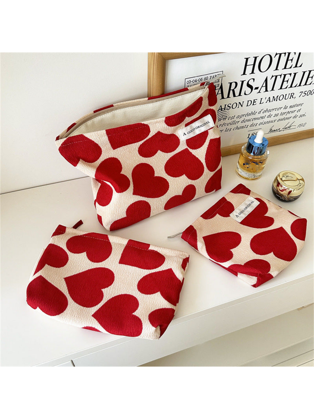 Large, Small and Trapezoid heart-pattern cosmetic pouches displayed together