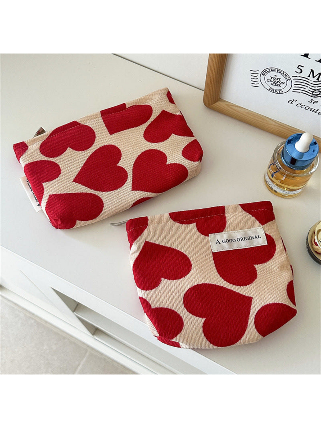 Small and Trapezoid heart-pattern pouches displayed flat side by side