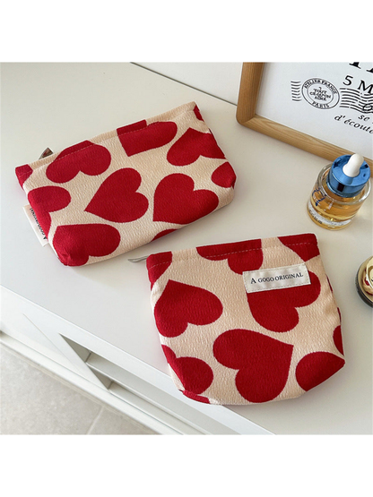 Small and Trapezoid heart-pattern pouches displayed flat side by side