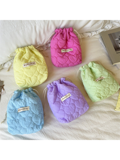 Yellow, Fuchsia, Mint, Blue and Purple heart-quilted drawstring pouches displayed together