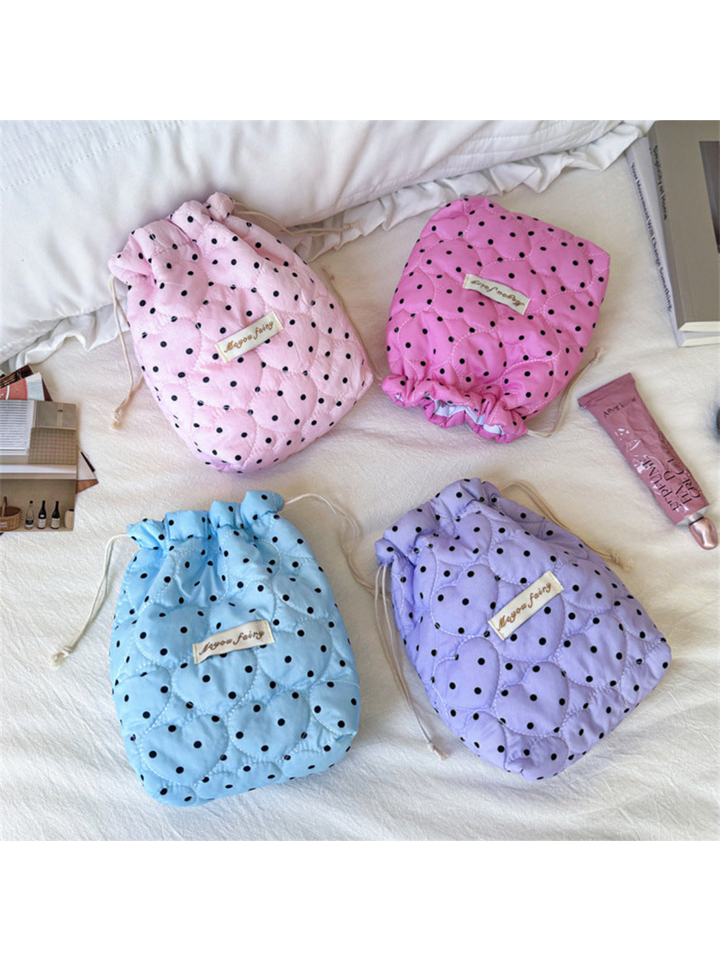 Pink, Rose Pink, Blue and Purple cosmetic pouches with black polka dots and heart-shaped quilting