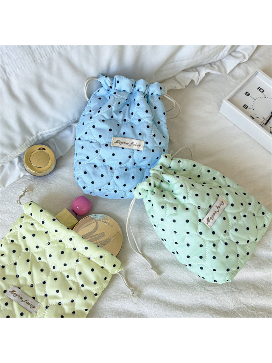 Blue and Mint drawstring cosmetic pouches beside a partially visible Cream pouch