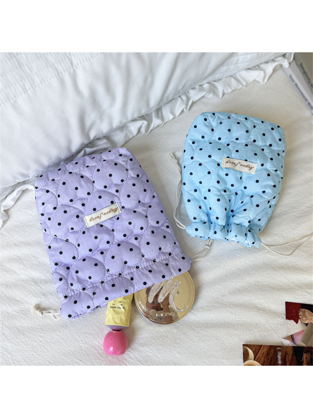 Purple and Blue quilted cosmetic pouches with drawstring openings facing downward