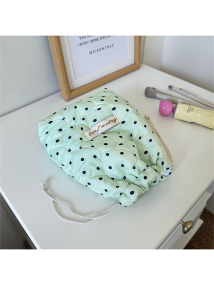 Mint cosmetic pouch with black polka dots, heart-shaped quilting and gathered drawstring opening