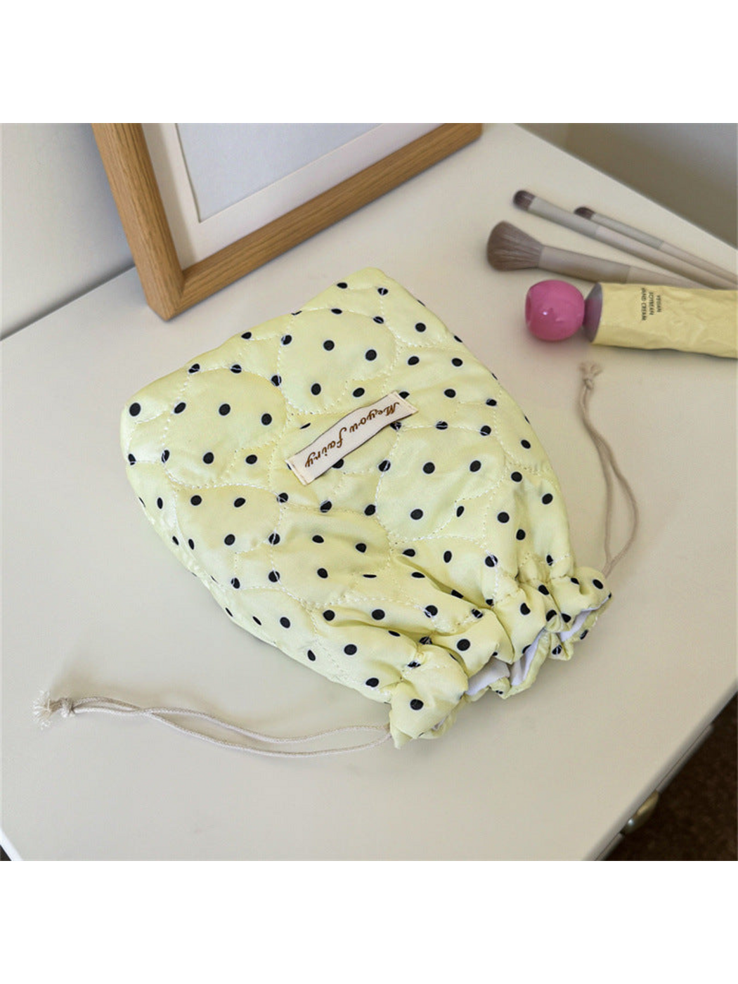 Cream cosmetic pouch with black polka dots, heart-shaped quilting and drawstrings