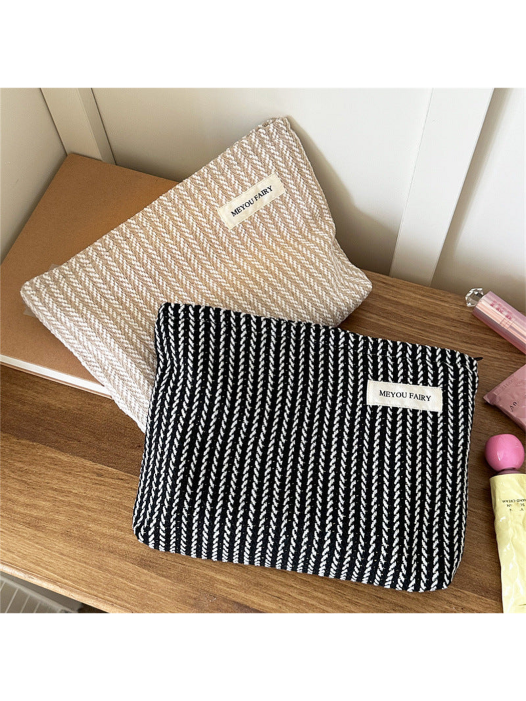 Black and Beige makeup pouches with contrasting textured stripes displayed together
